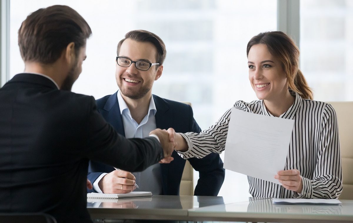 Happy employers shake hand of male job candidate, congratulating with given position, satisfied HR managers happy to hire applicant handshake greeting at team. Successful good interview concept