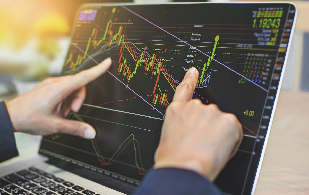 top view of business people working with stock trading forex with technical indicator tool on laptop
